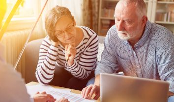 Elderly Couple checking paperwork to save on engergy costs